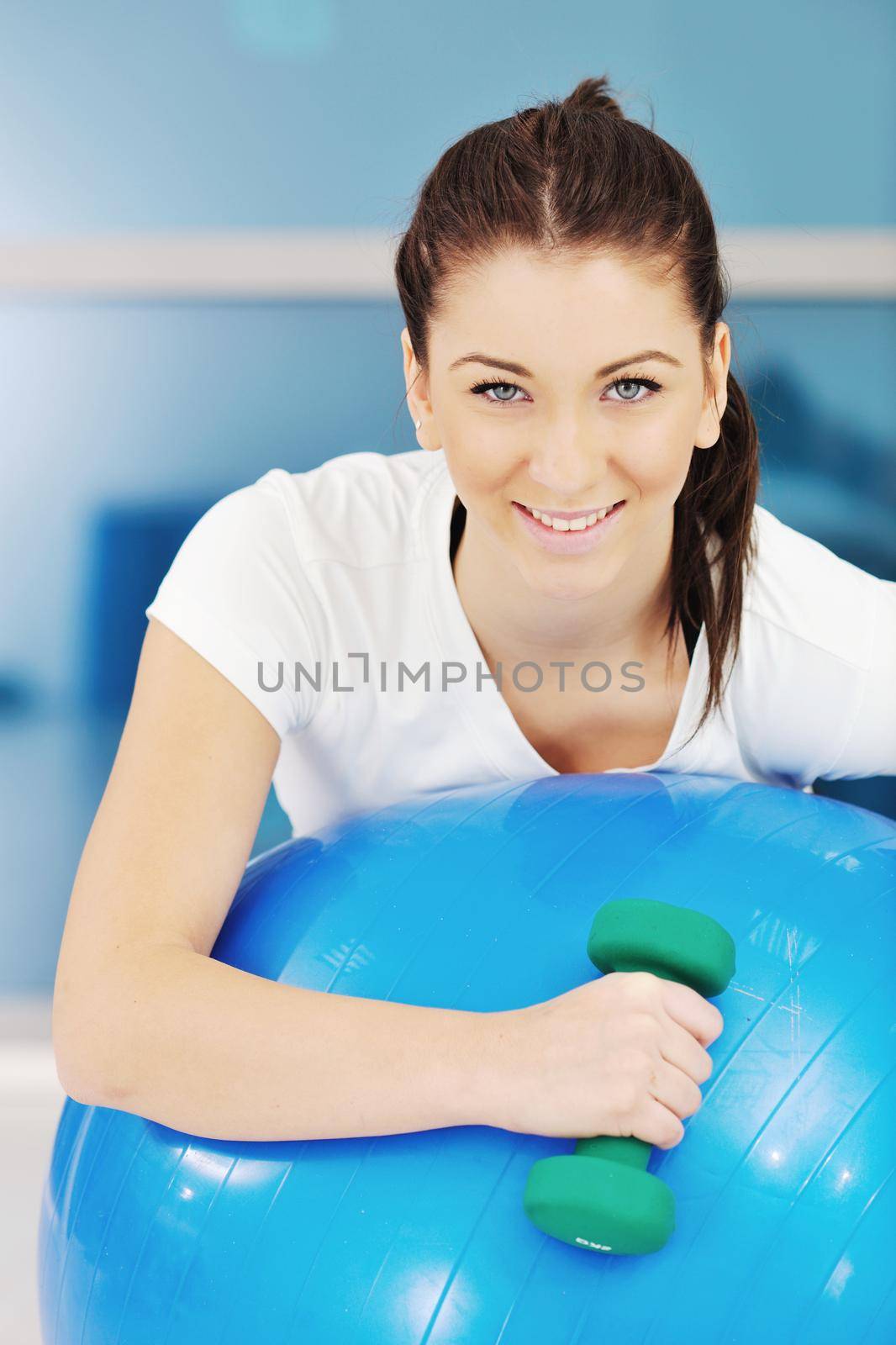 beaudiful young woman fitness workout with weights at sport club