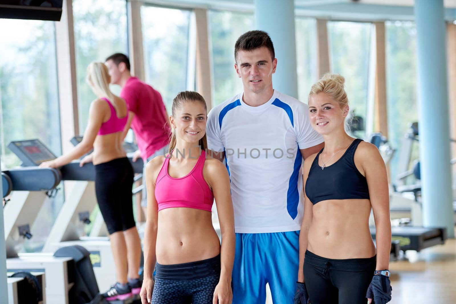 group portrait of healthy and fit young people in fitness gym