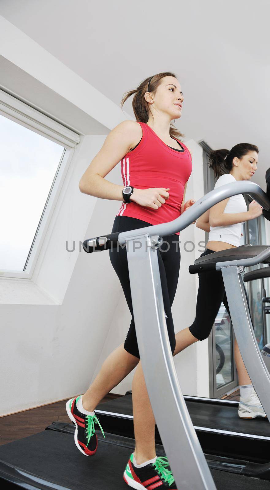young woman exercise fitness and workout while run on track in sport club