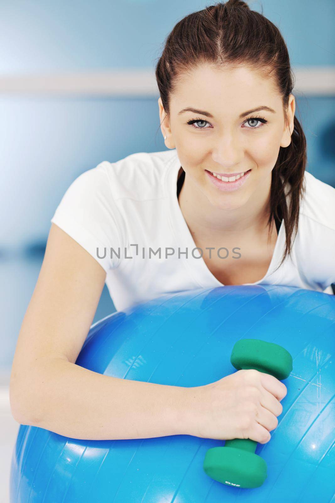 beaudiful young woman fitness workout with weights at sport club