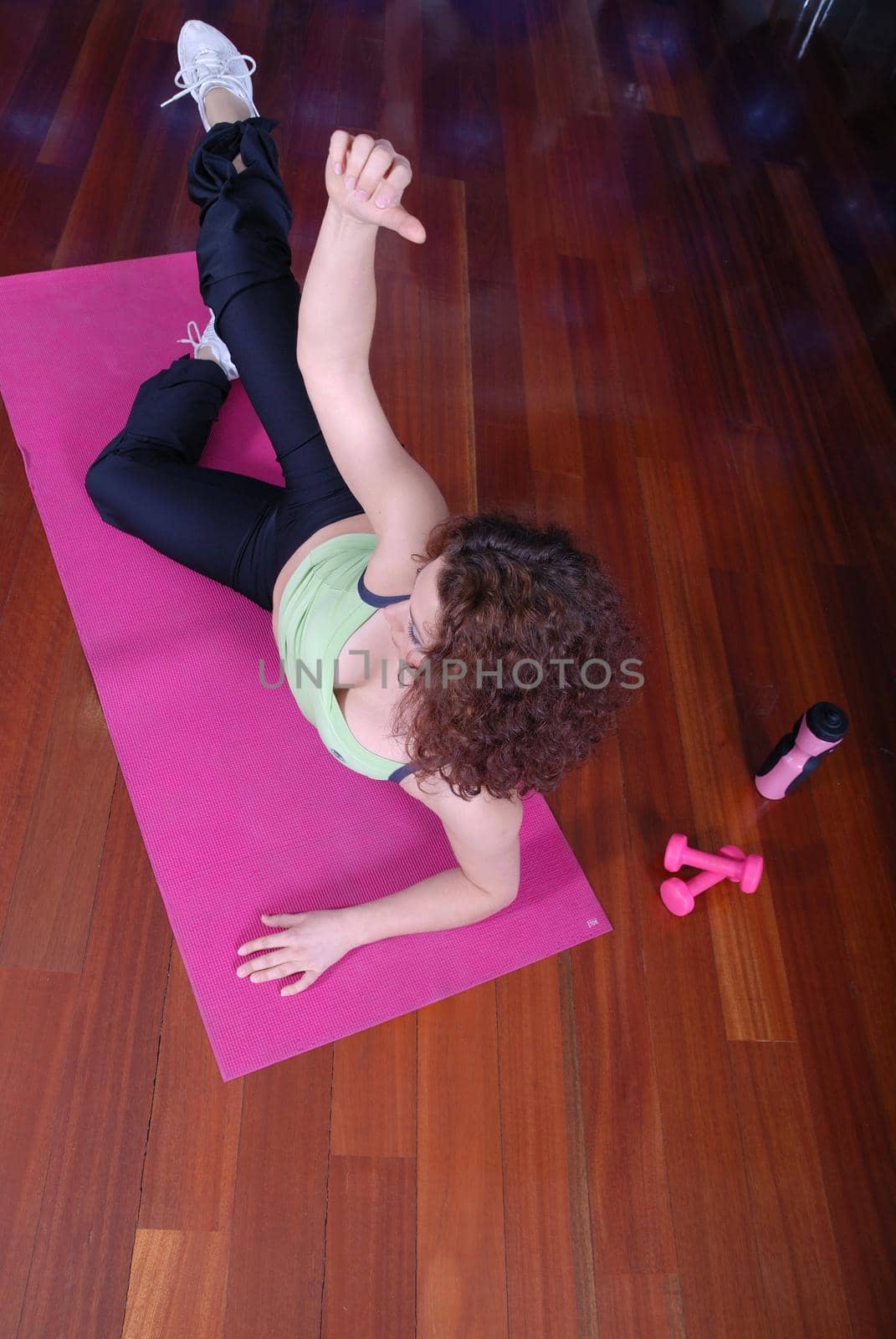 young pretty woman exercising in a fitness center