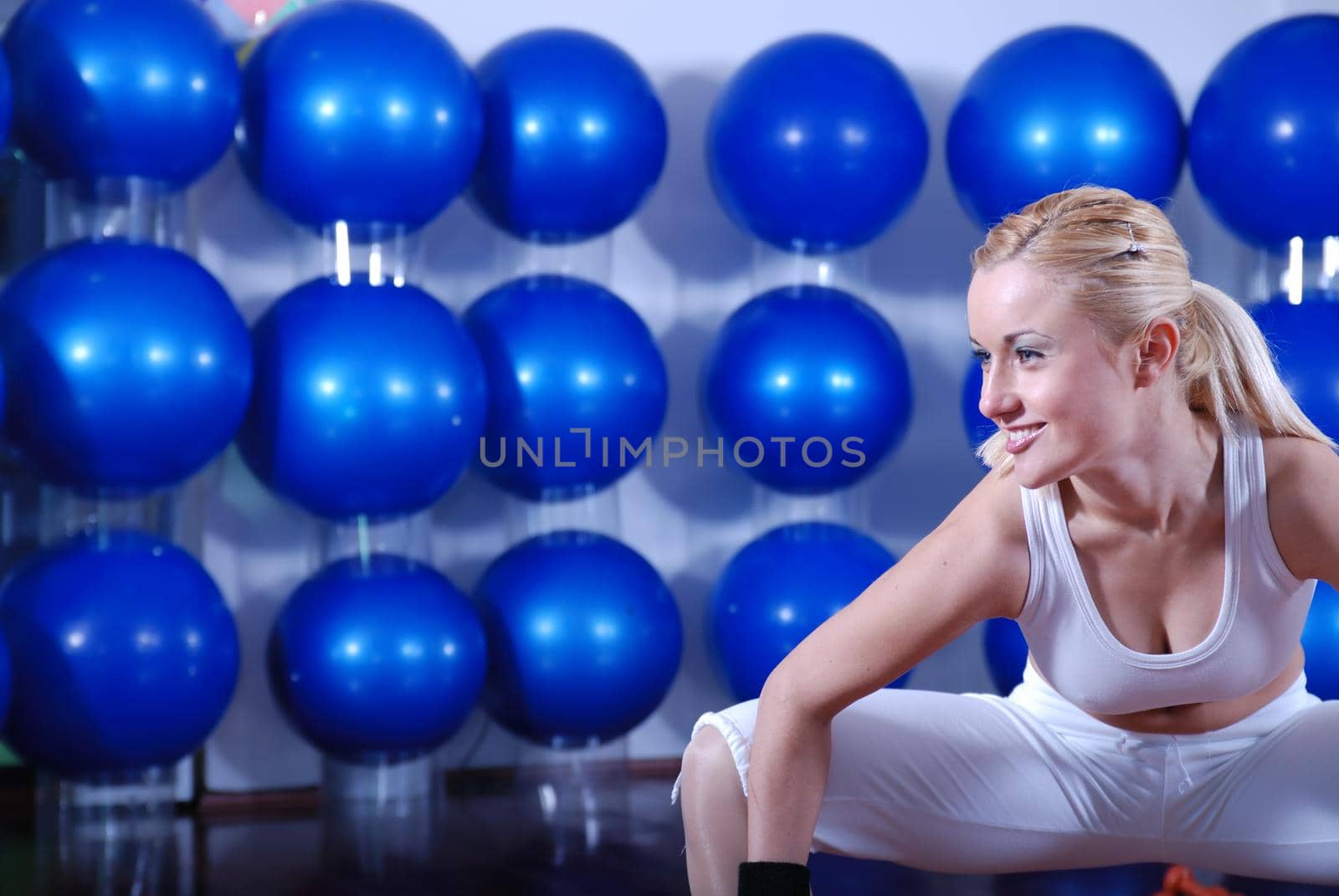 young woman exercising with pilates ball by dotshock