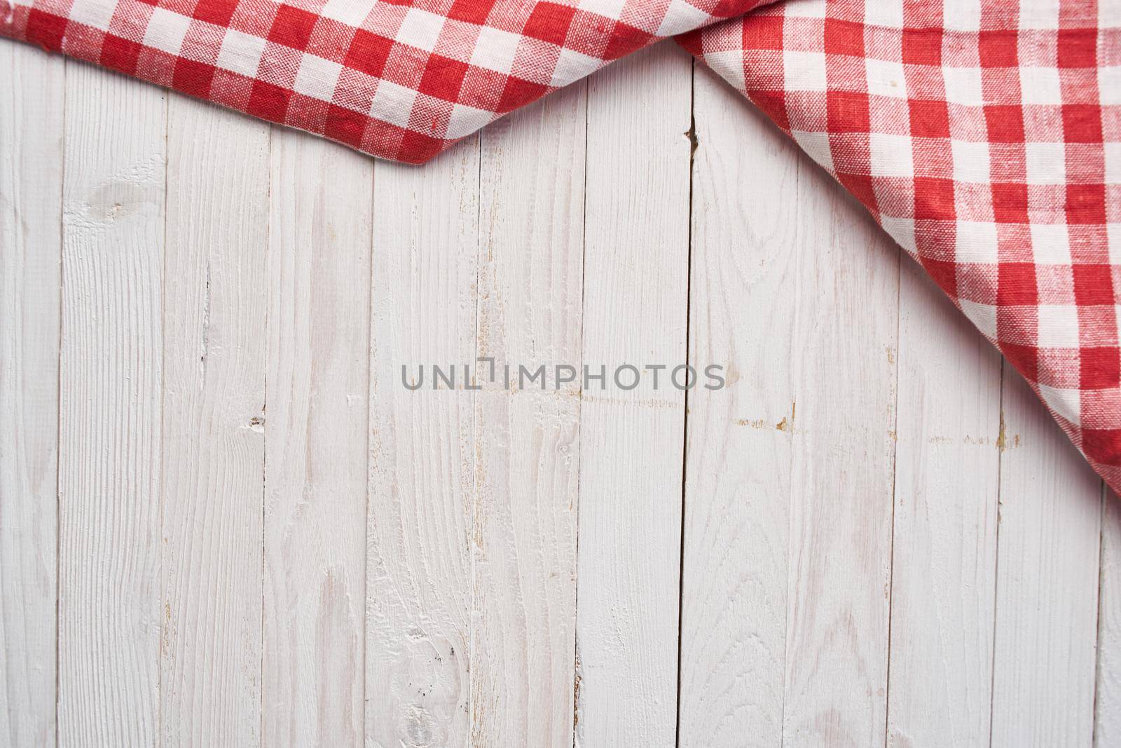 Red checkered tablecloth wooden background texture kitchen decoration. High quality photo