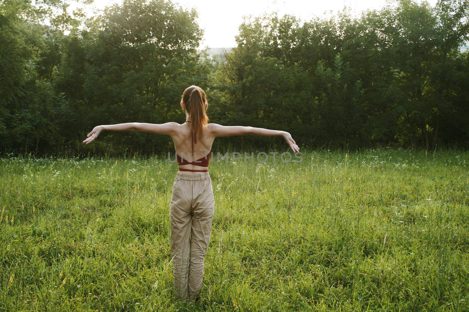 woman in a field outdoors summer meditation fresh air. High quality photo