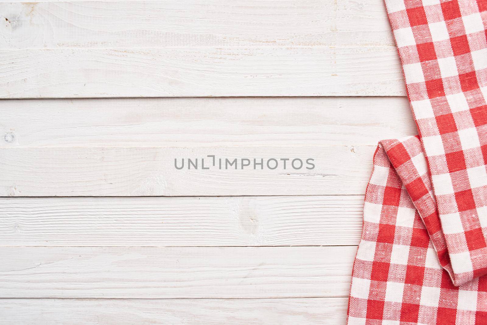 Red checkered tablecloth wooden background texture kitchen decoration. High quality photo