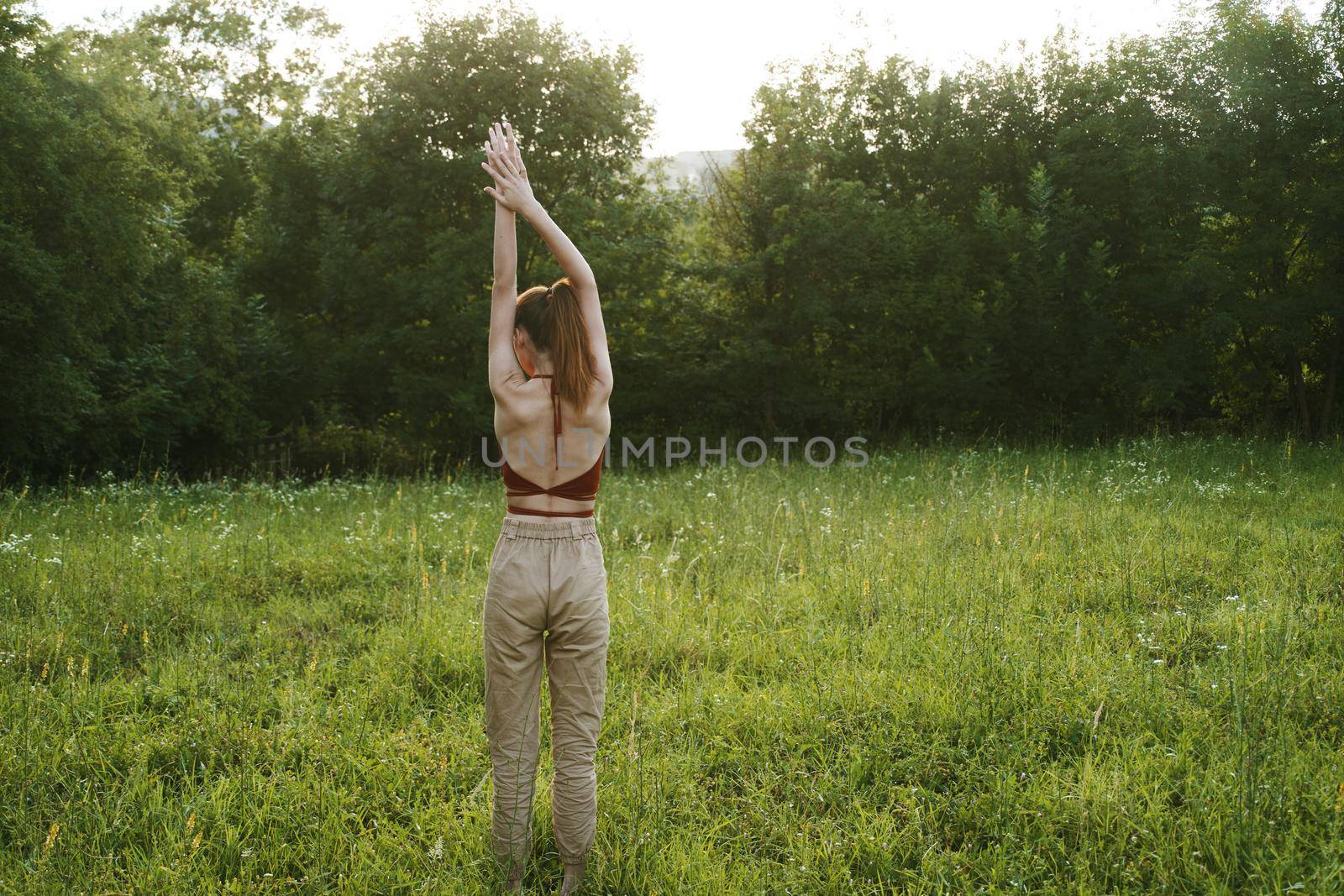 woman exercising outdoors freedom summer nature. High quality photo