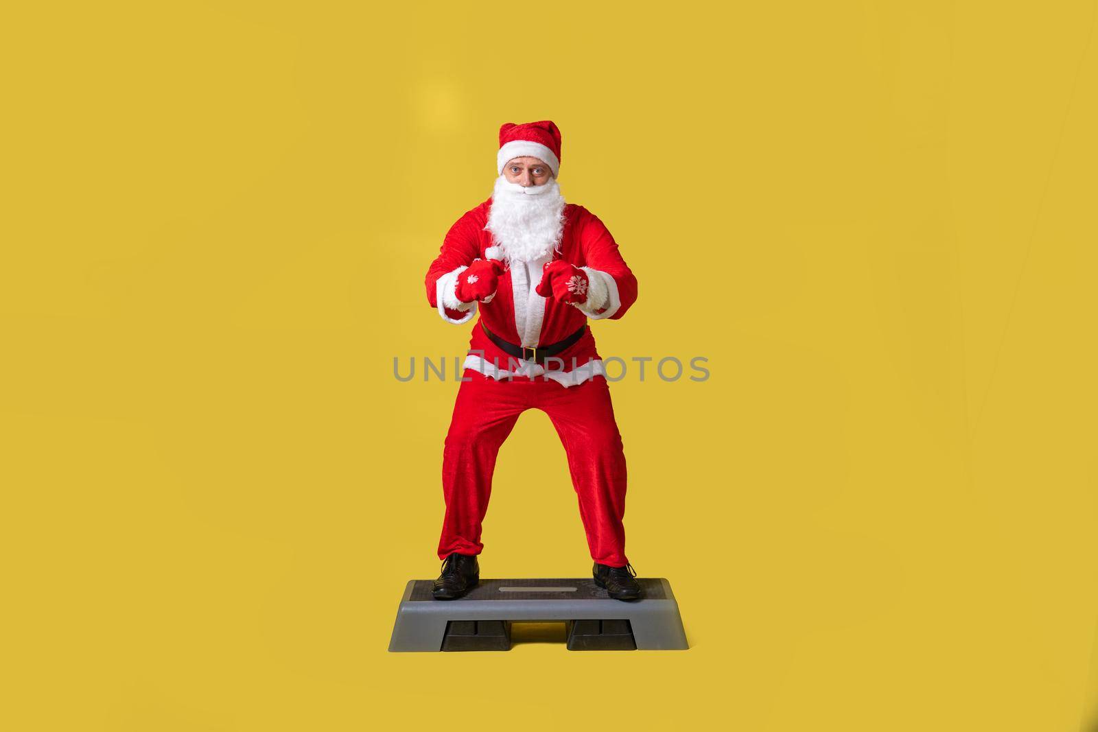 Santa claus yellow style, fat christmas winter senior, december happy. Fashionable Caucasian grandfather, time on step platform fitness