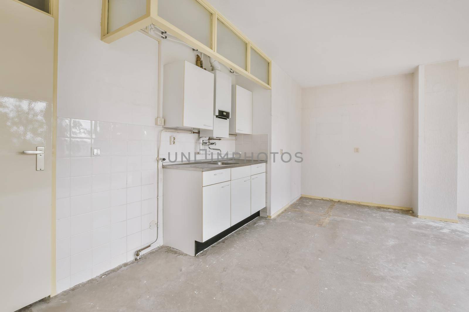 A cozy and spacious room with small kitchen