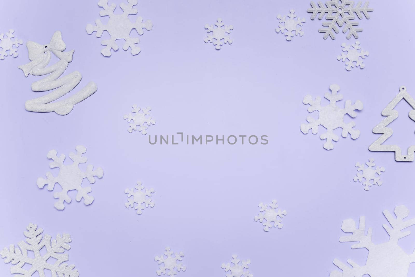 Minimalist Christmas toys in trendy 2022 colors set against Very Peri background. Christmas, new year concept, winter.