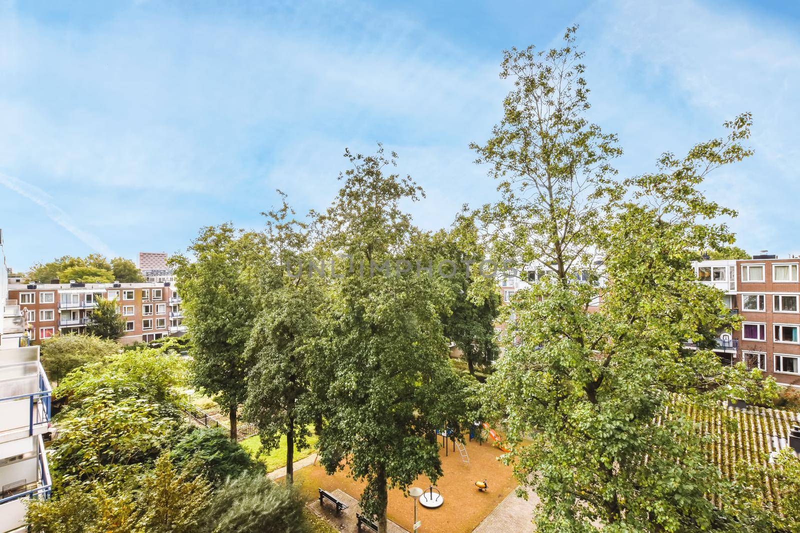 A gorgeous top view of the courtyard of the house with many trees and a playground
