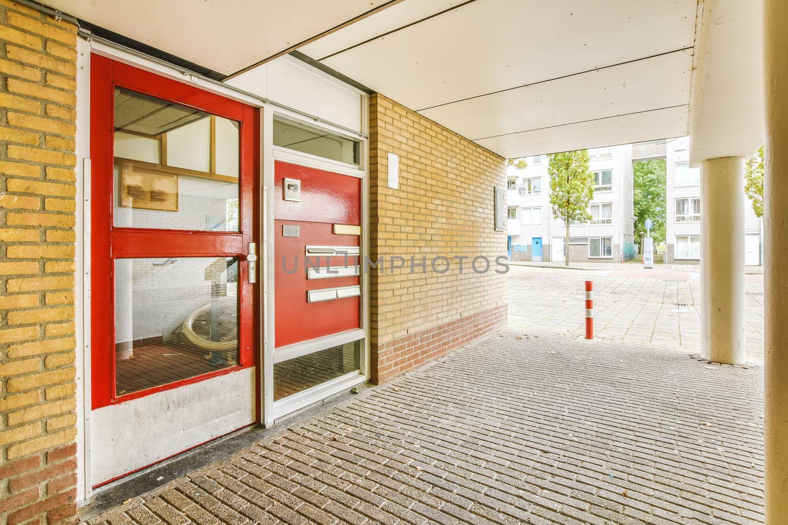 Residential building front door with red door