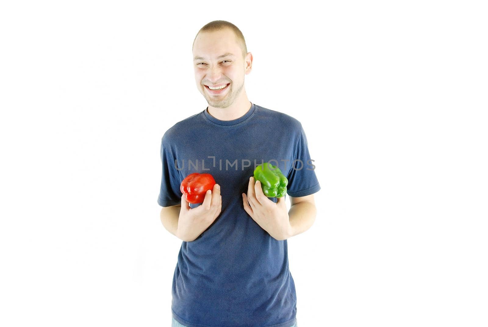 happy couple holding peppers with head by dotshock