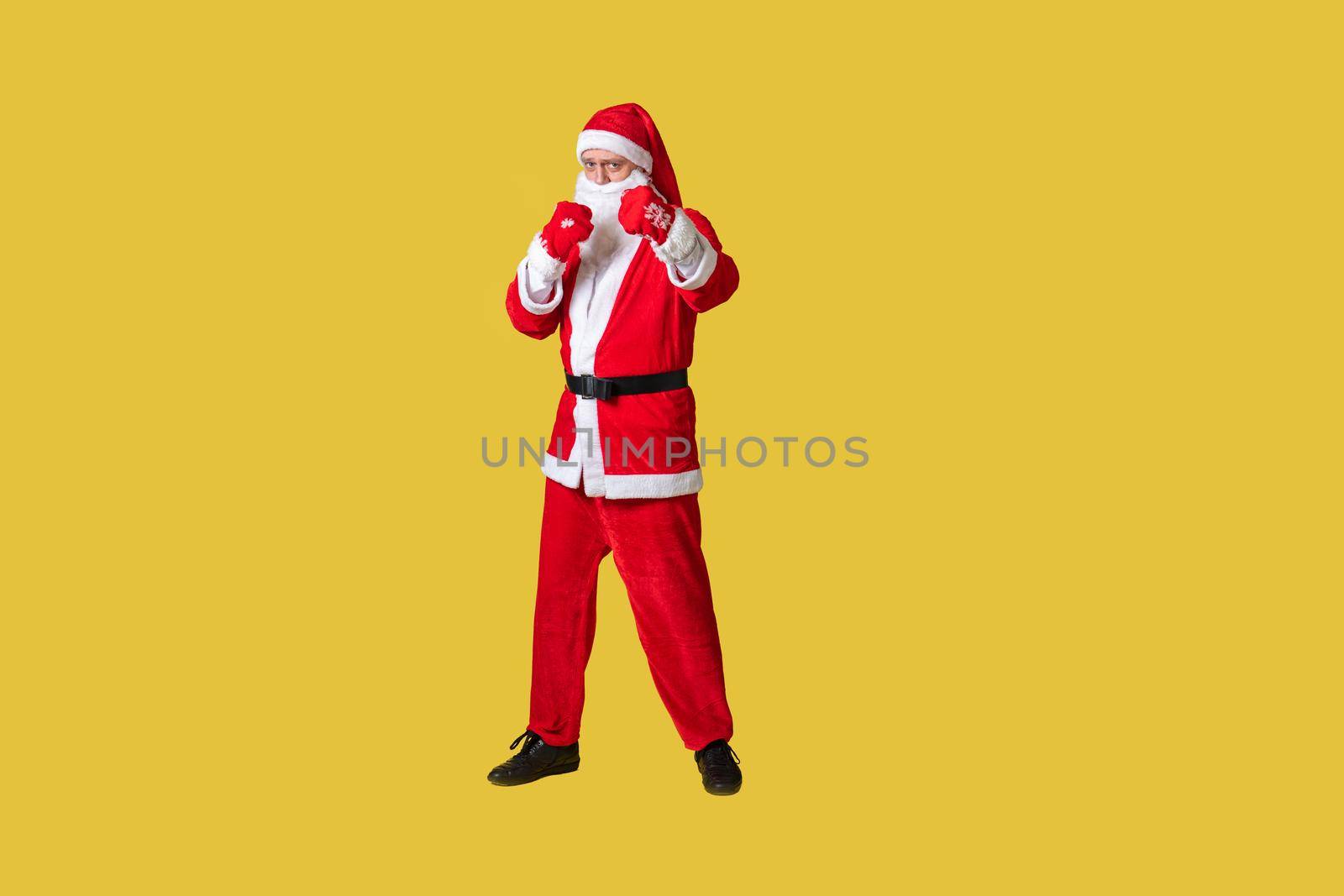 Santa claus yellow funky big, fat holiday christmas man aged, december people. Hat cheerful, celebrate in boxing gloves