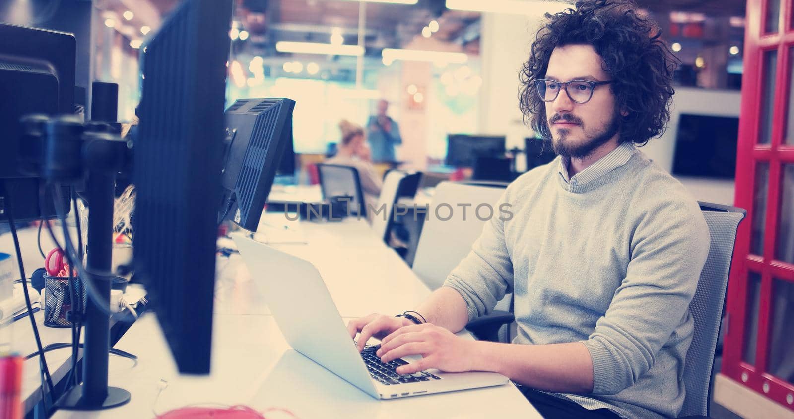 Young Entrepreneur Freelancer Working Using A Laptop In Coworking space