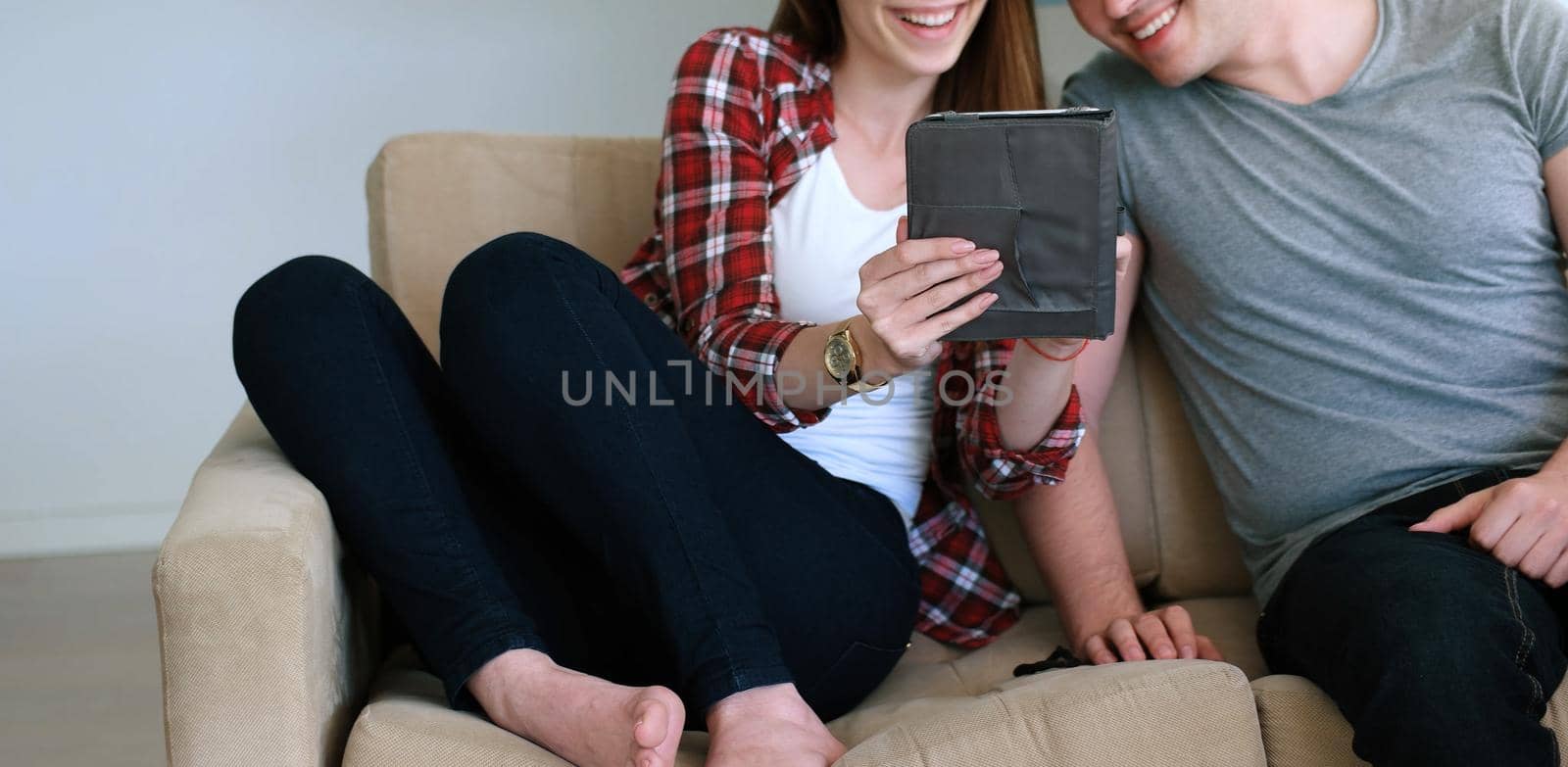 Young Couple using digital tablet at home by dotshock