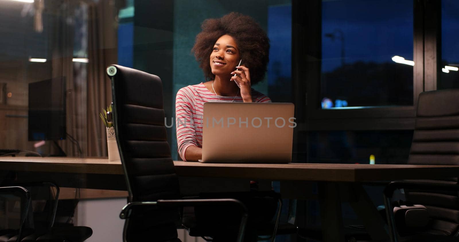 Young african american female Entrepreneur Freelancer Working Using A Laptop In night Coworking space