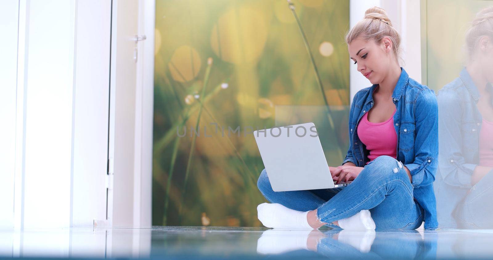 beautiful young women using laptop computer on the floor of her luxury home