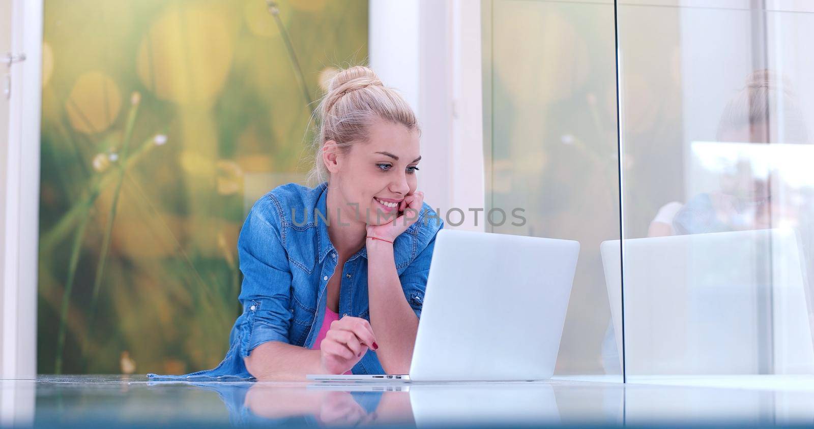 beautiful young women using laptop computer on the floor of her luxury home