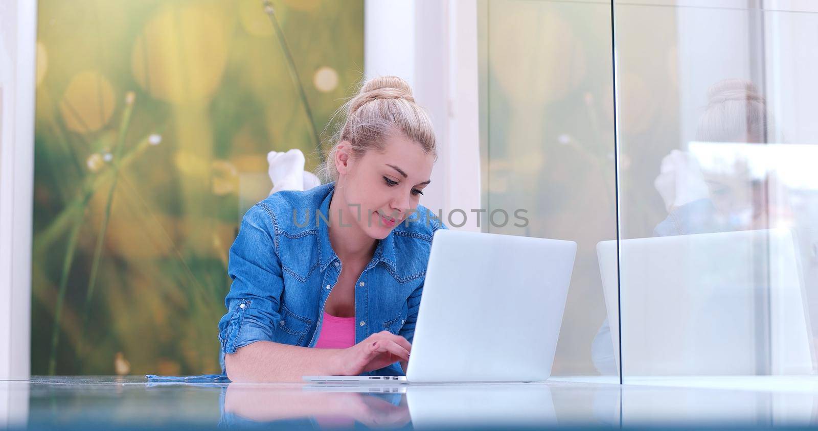 beautiful young women using laptop computer on the floor of her luxury home