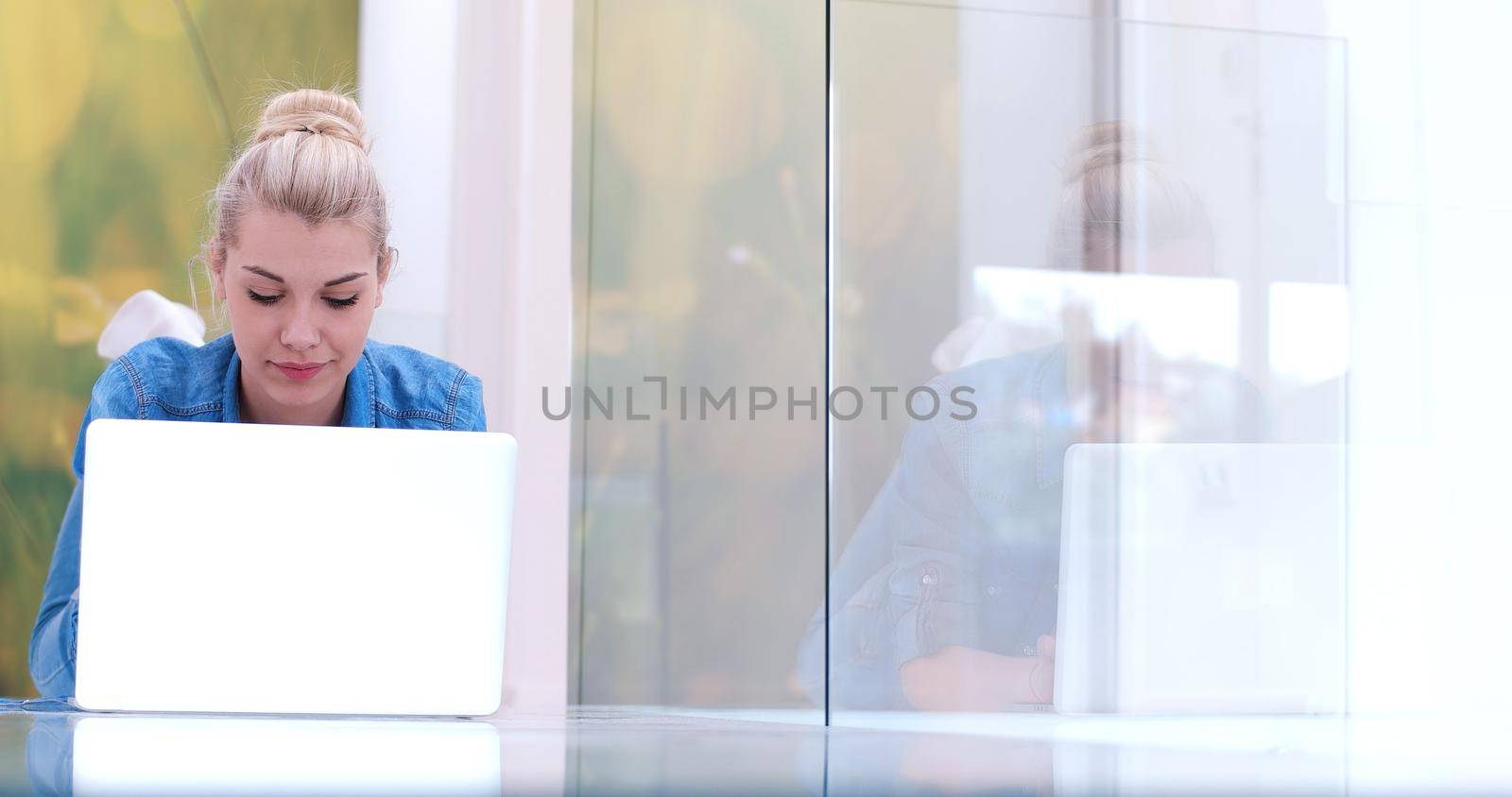 beautiful young women using laptop computer on the floor of her luxury home