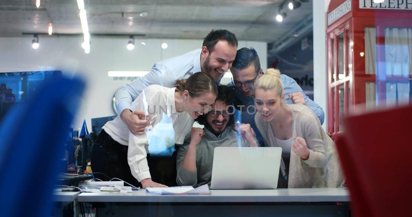 Group of a young business people discussing business plan at modern startup office building