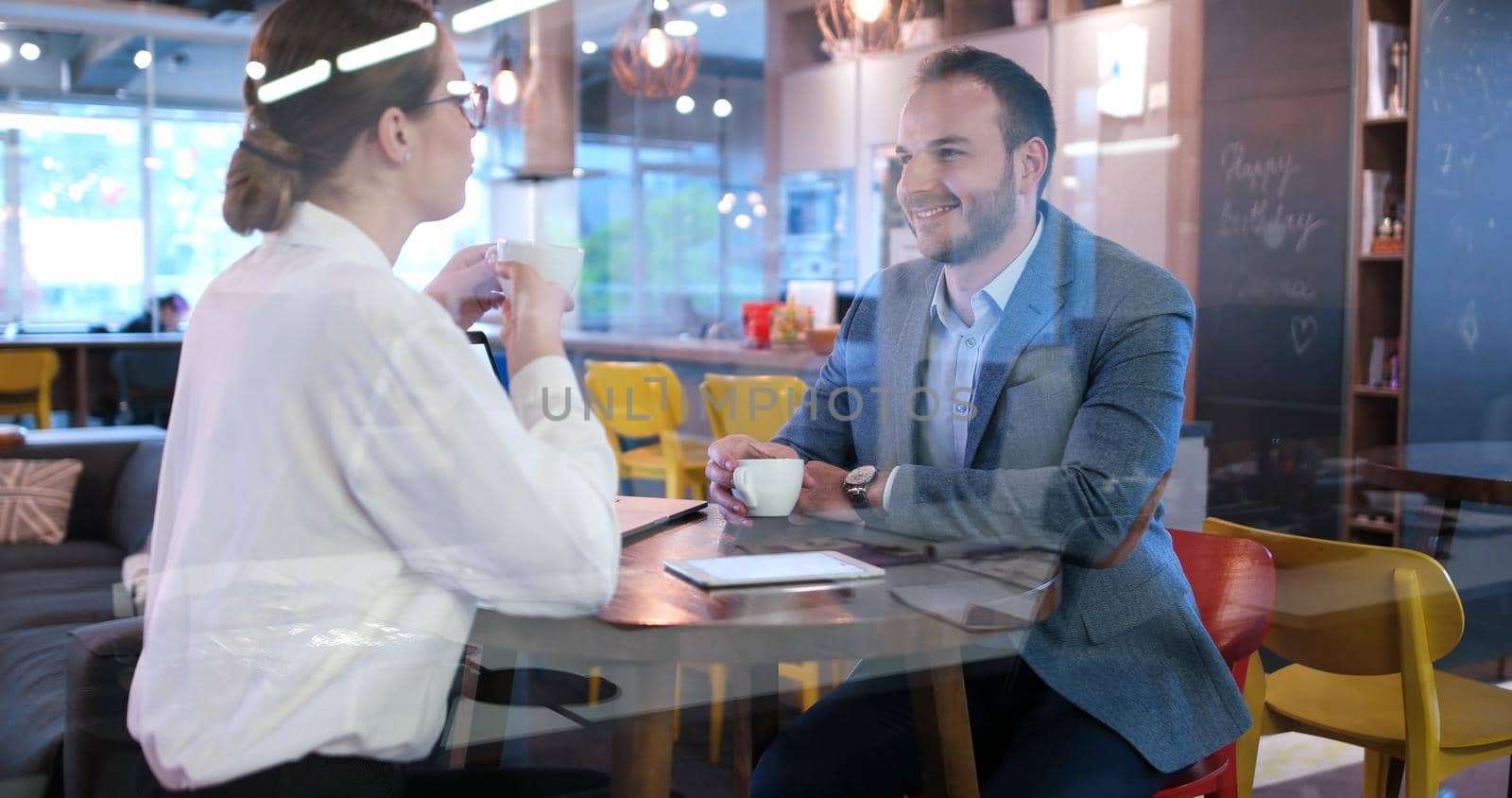 Group of a young business people discussing business plan at modern startup office building