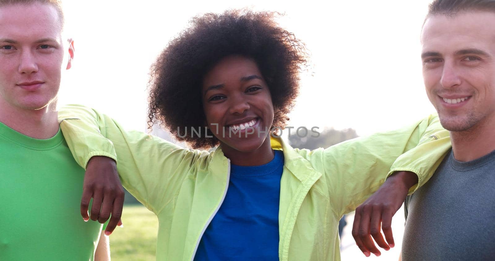 Portrait of multiethnic group of young people on the jogging beautiful summer morning as the sunrise over the city