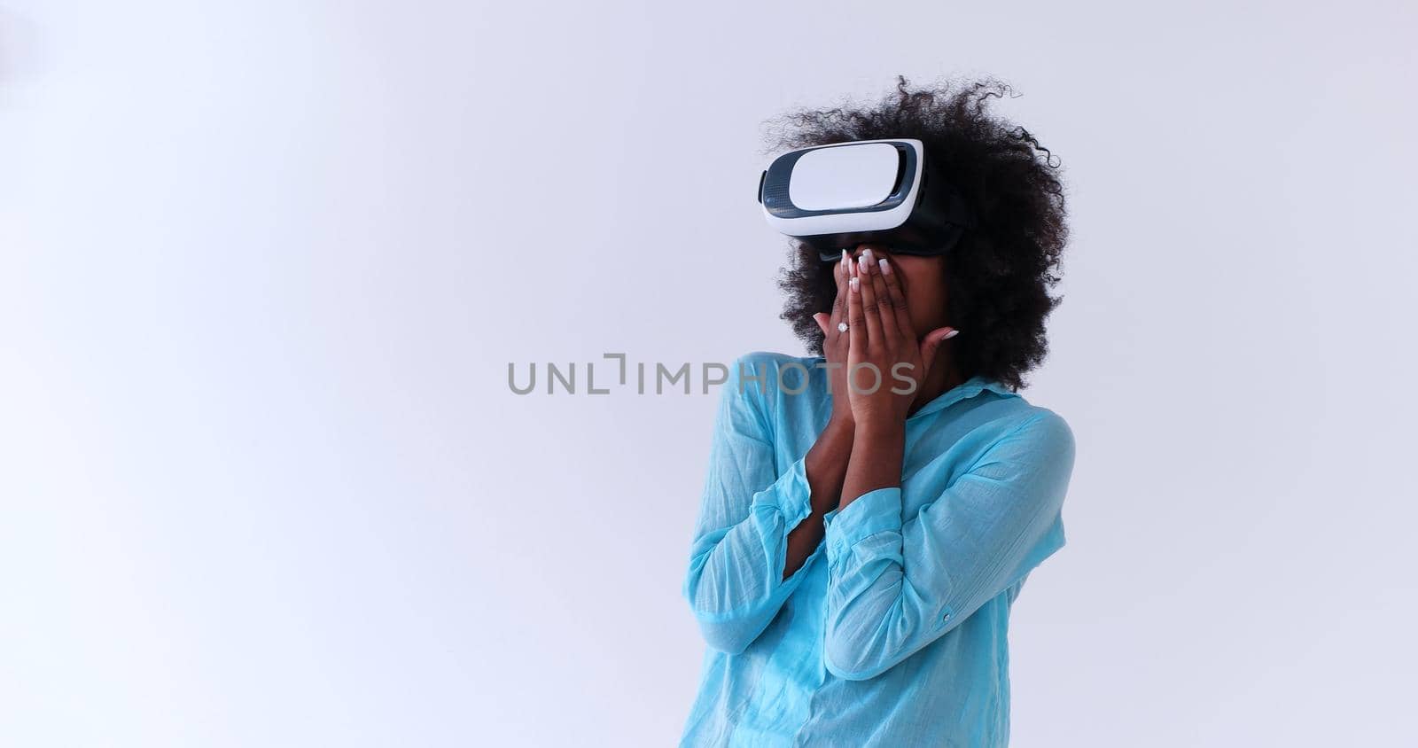 Happy african american girl getting experience using VR headset glasses of virtual reality, isolated on white background