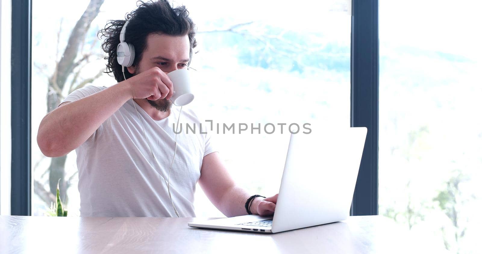 Real man Using laptop At Home Drinking Coffee Enjoying Relaxing