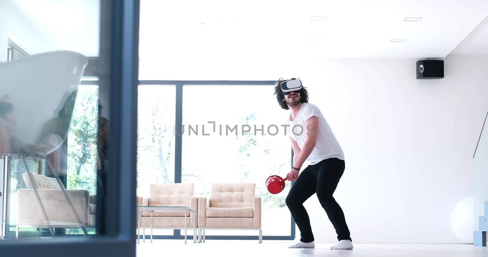 happy man getting experience using VR-headset glasses of virtual reality at home