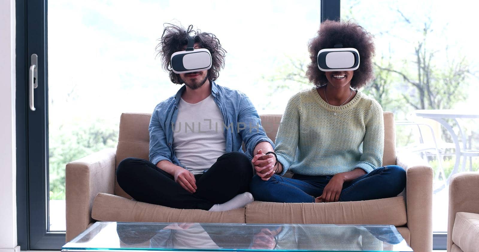 Multiethnic Couple using virtual reality headset in living room at home  people playing game with new trends technology