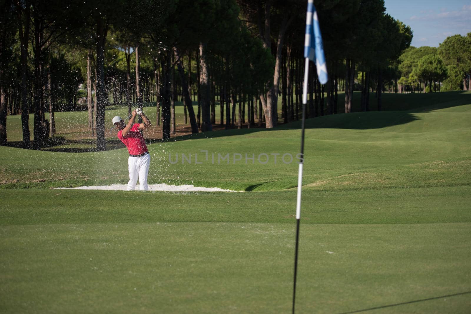 golfer hitting a sand bunker shot by dotshock