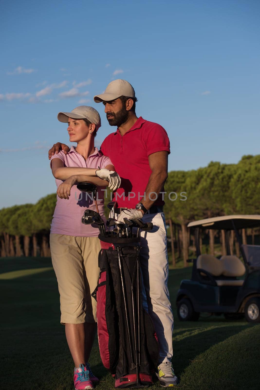 portrait of happy young  couple on golf course