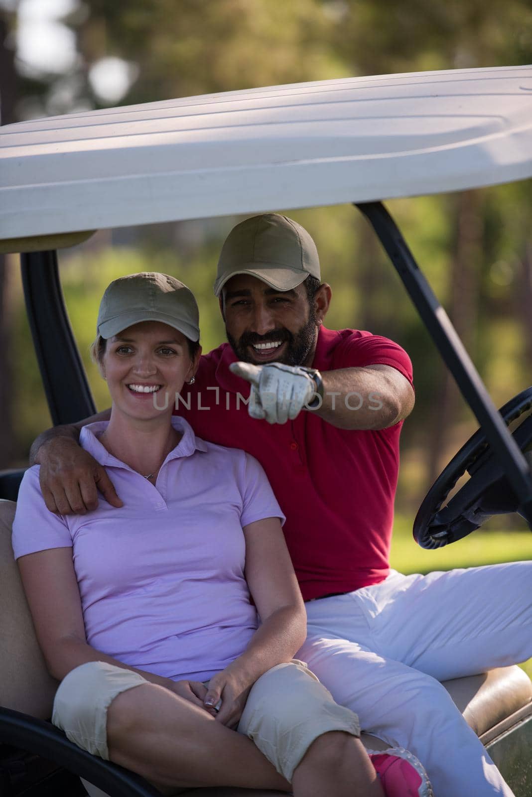 couple in buggy cart on golf course