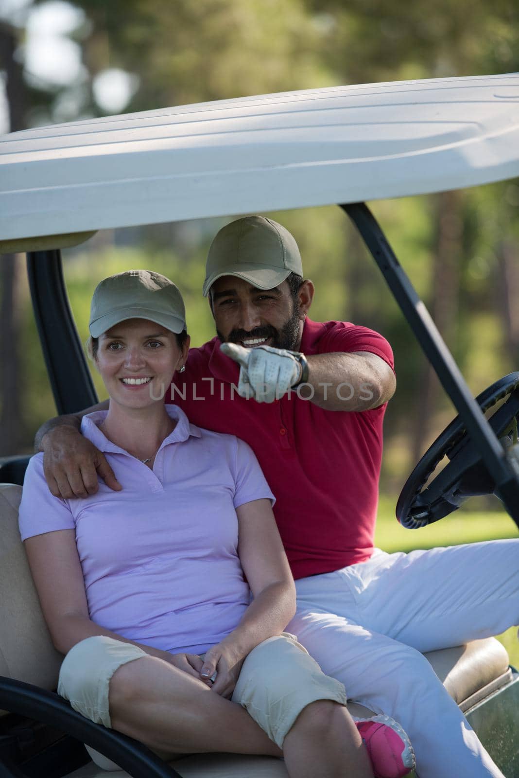 couple in buggy cart on golf course