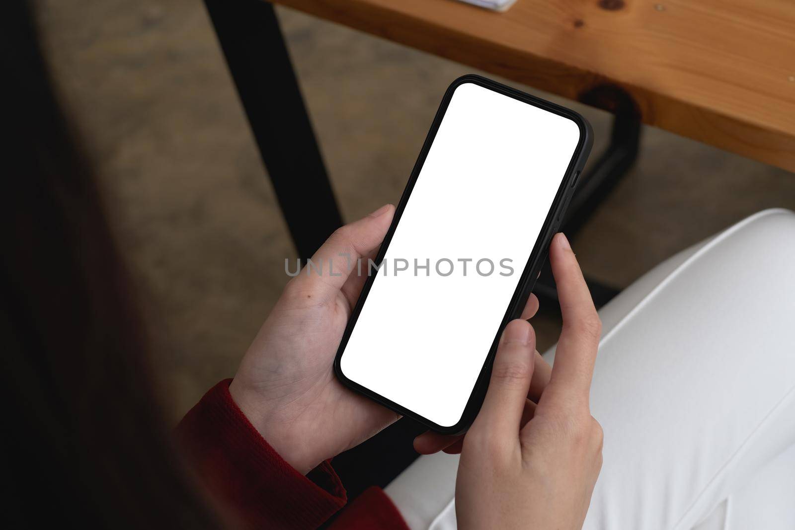 A Woman showing mobile phone screen. Blank screen for your advertising