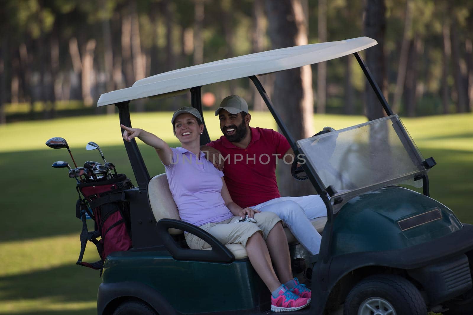 couple in buggy cart on golf course