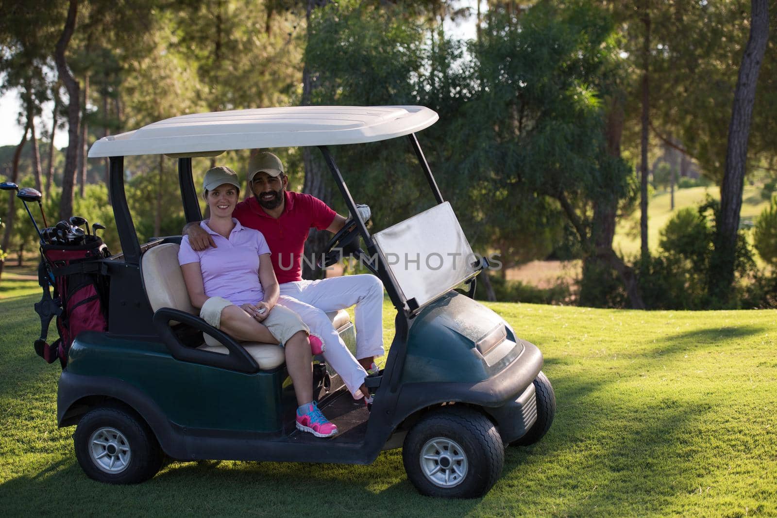 couple in buggy cart on golf course