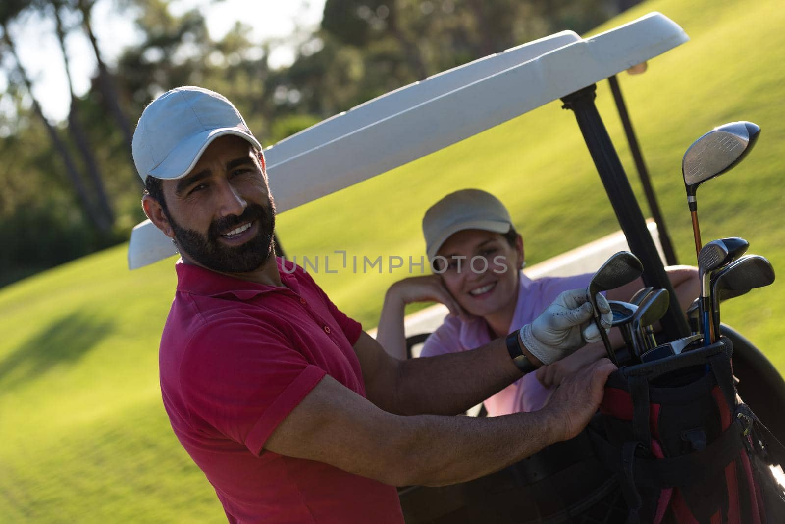 couple in buggy cart on golf course