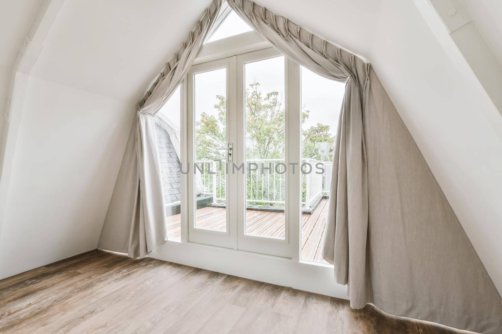 Large doors of unusual shape leading to the balcony
