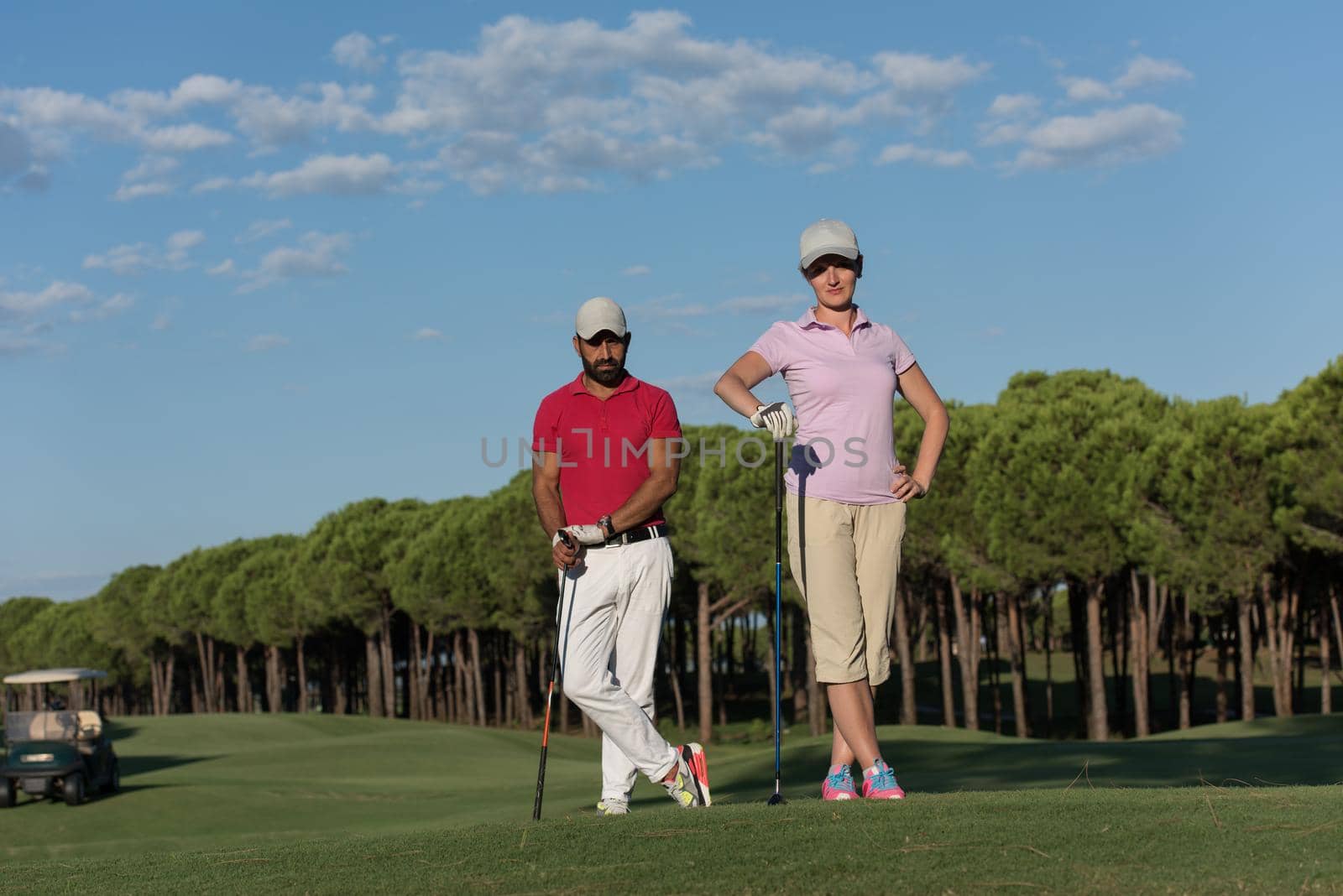 portrait of happy young  couple on golf course