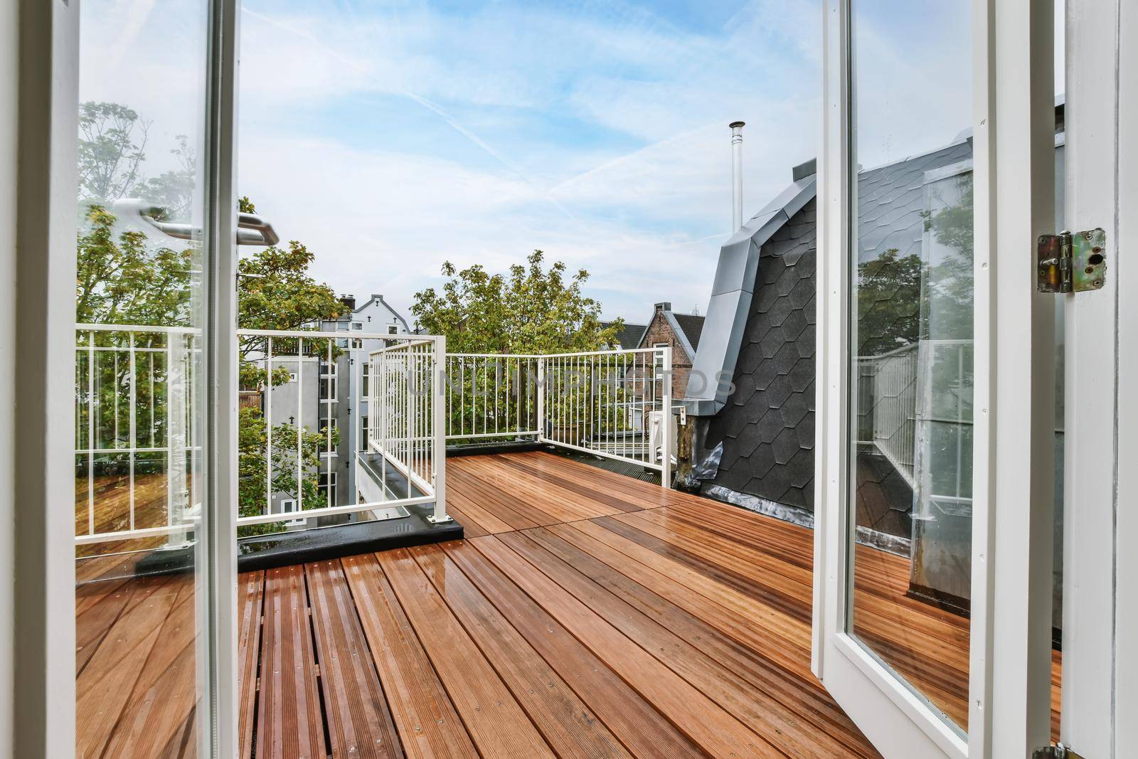 Rooftop exterior with delightful wood flooring and white railings