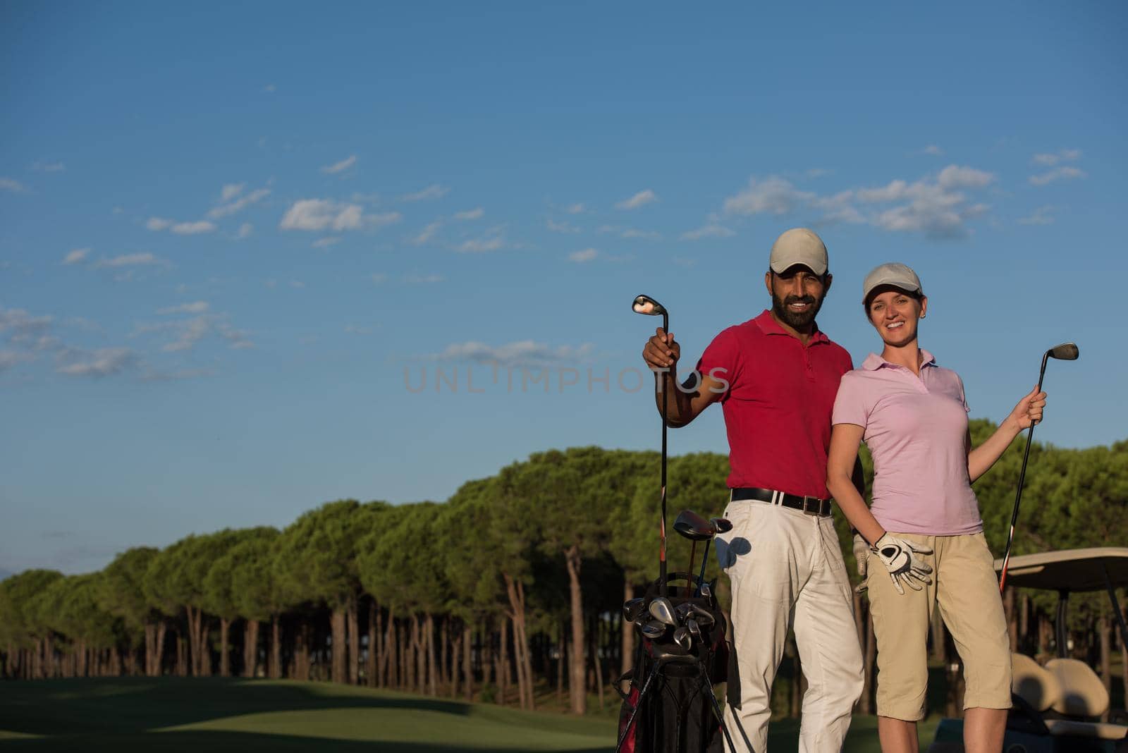 portrait of happy young  couple on golf course