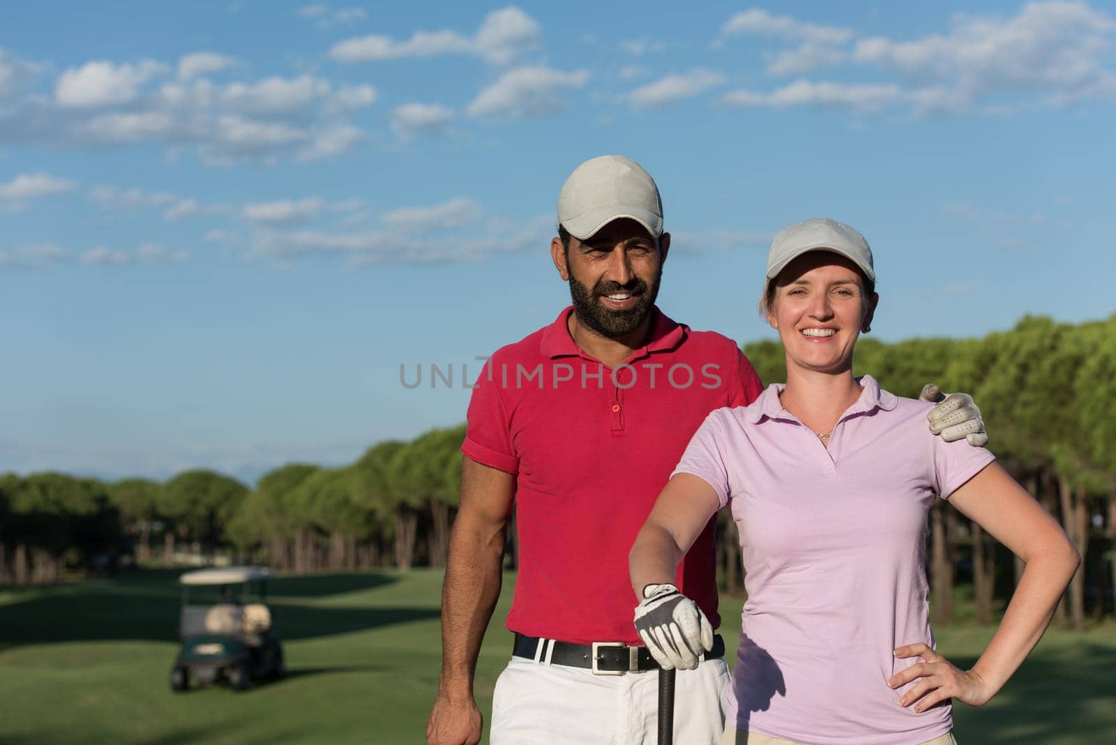 portrait of happy young  couple on golf course