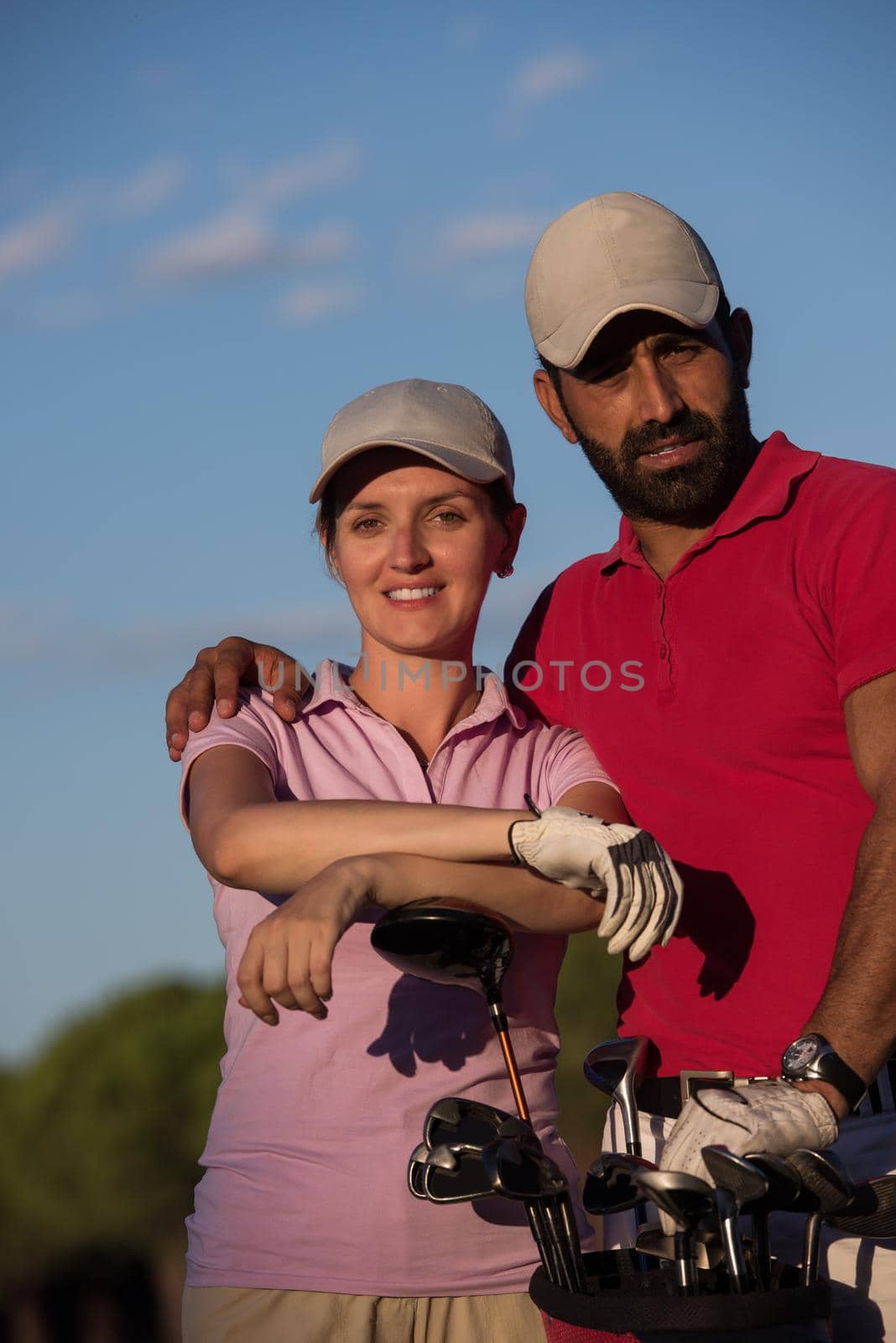 portrait of happy young  couple on golf course