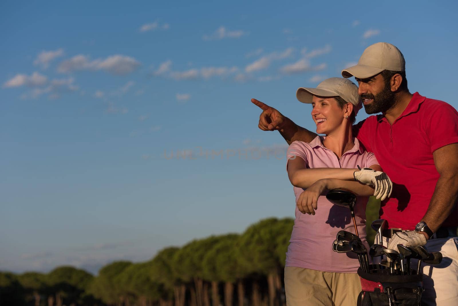 portrait of happy young  couple on golf course