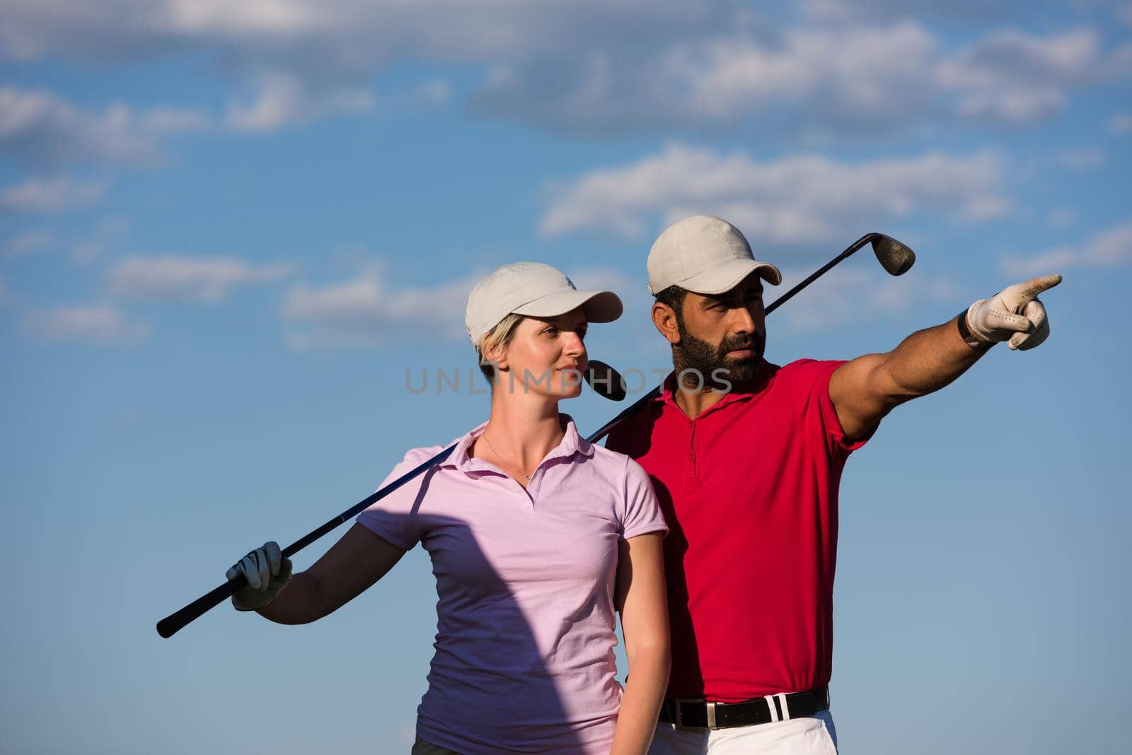 portrait of happy young  couple on golf course