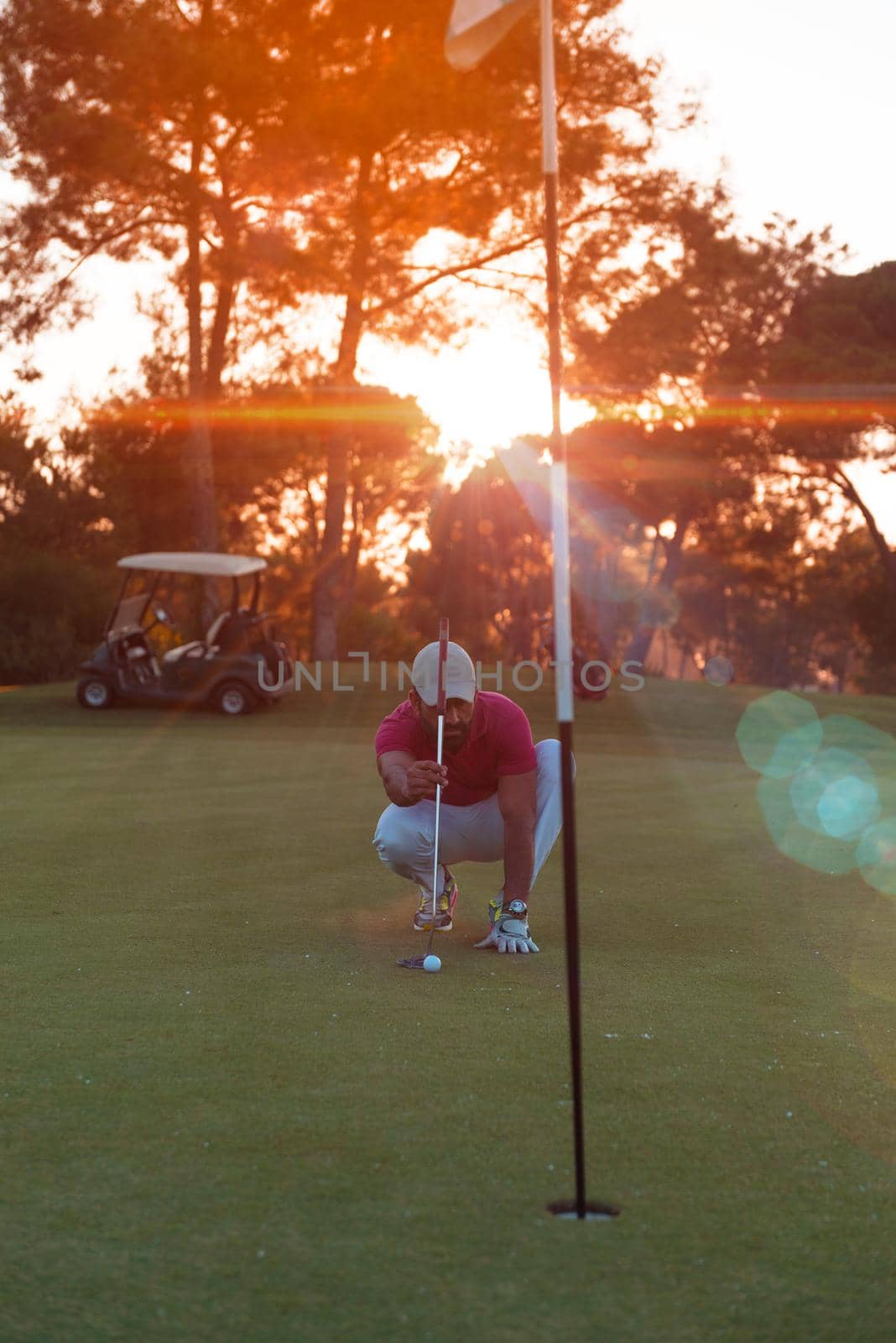 golf player aiming perfect  shot on beautiful sunset by dotshock
