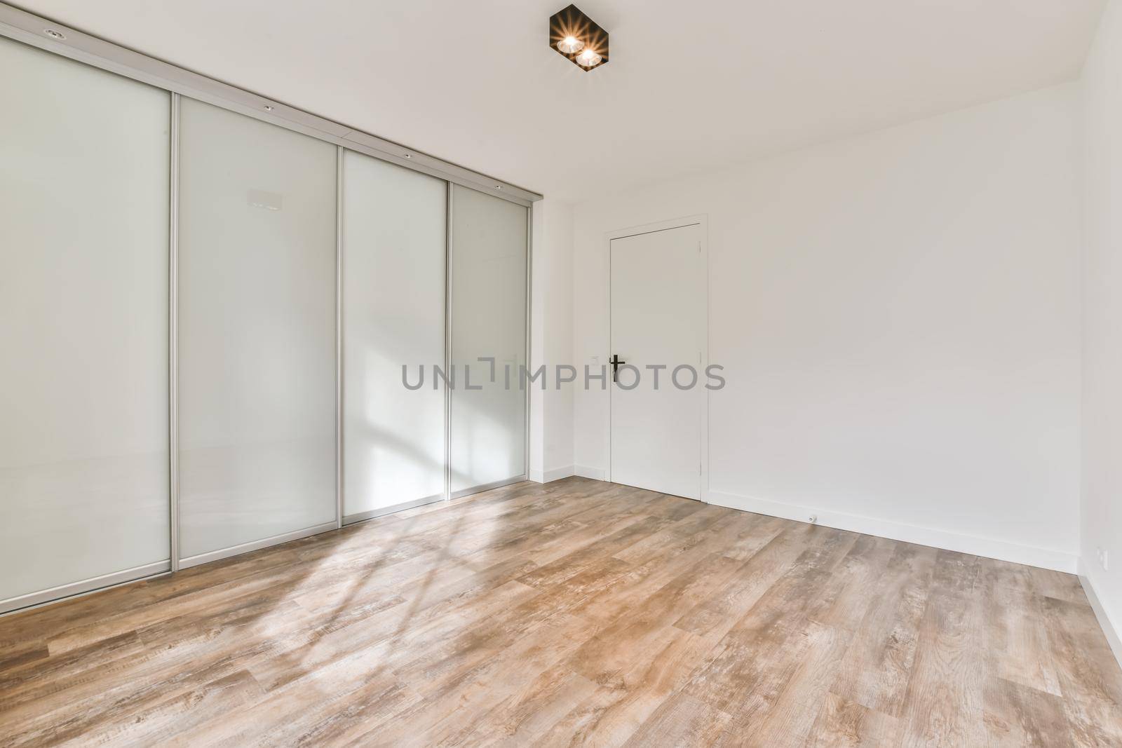 Interior of a spacious room with beautifully laid parquet in an elite house