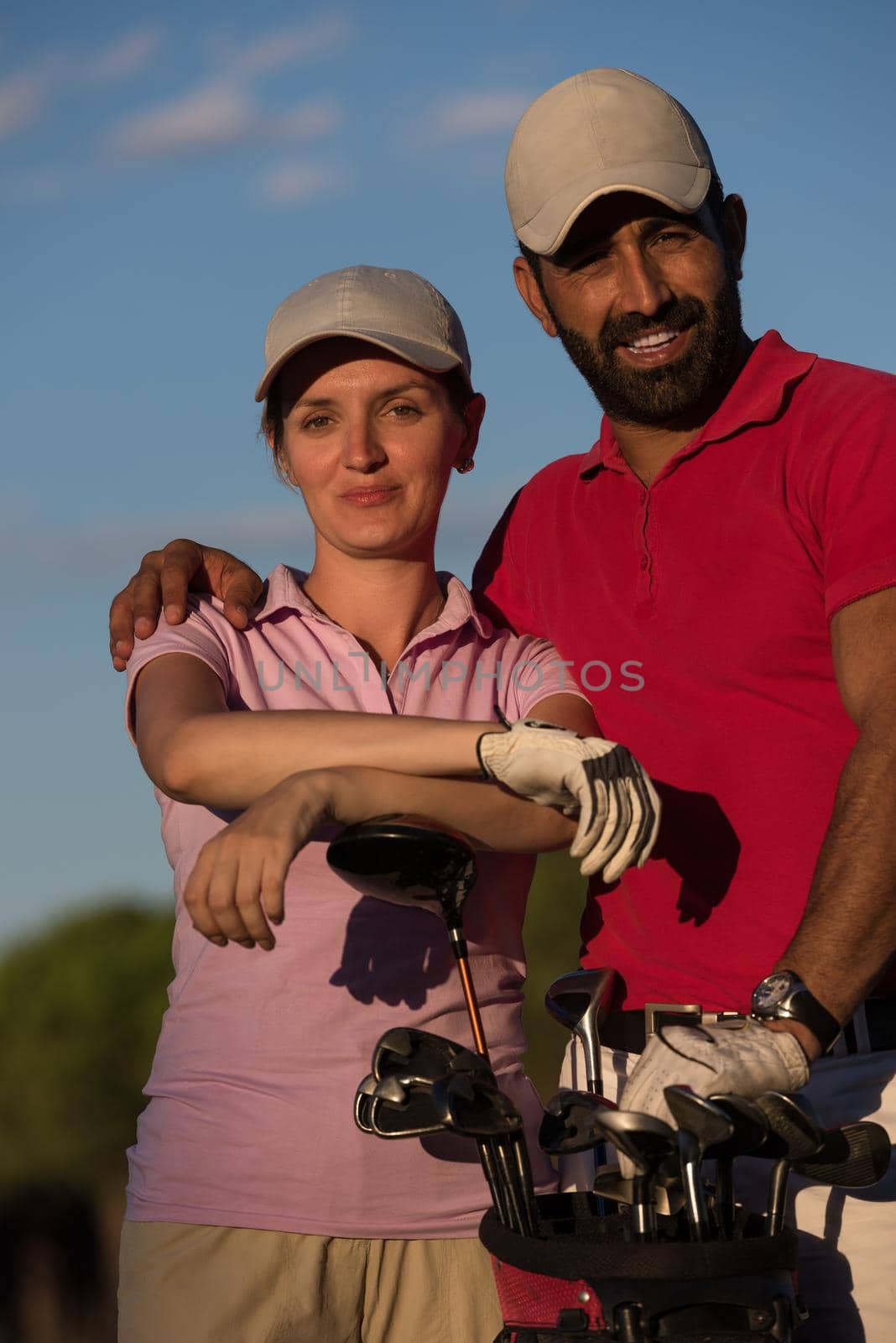 portrait of happy young  couple on golf course